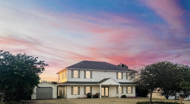 view of front of home with a garage and an outdoor structure