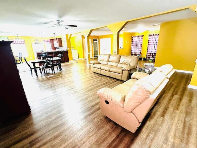 living room with ceiling fan, dark hardwood / wood-style floors, and washer / clothes dryer