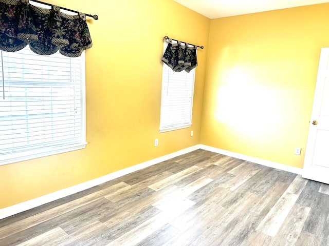 unfurnished room featuring hardwood / wood-style flooring