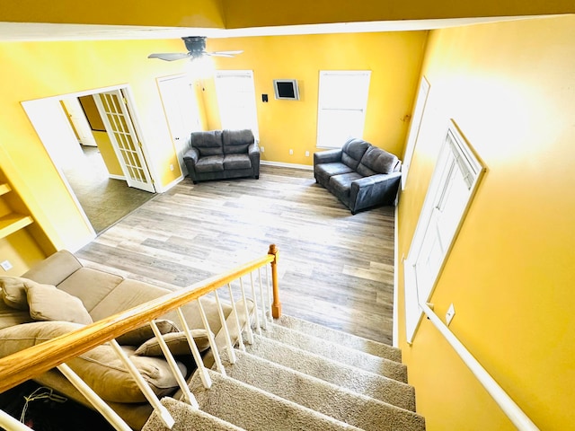 staircase featuring hardwood / wood-style flooring and ceiling fan