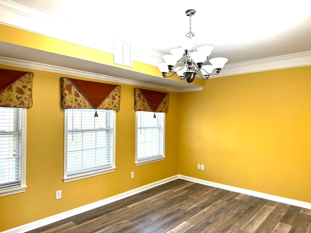 unfurnished room with ornamental molding, dark wood-type flooring, a wealth of natural light, and a chandelier