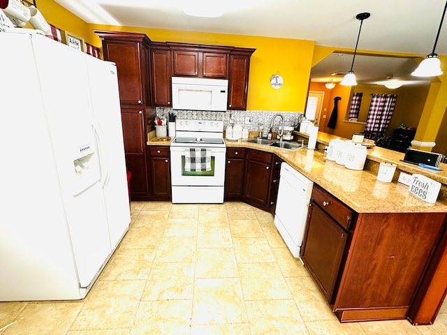 kitchen featuring sink, kitchen peninsula, pendant lighting, white appliances, and decorative backsplash