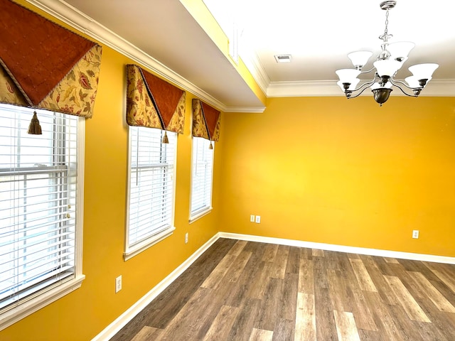 unfurnished dining area featuring ornamental molding, a chandelier, and hardwood / wood-style floors