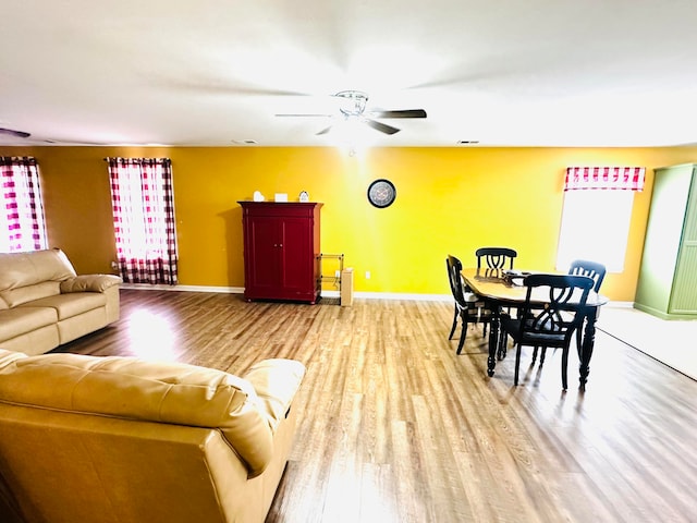 living room featuring ceiling fan and light wood-type flooring