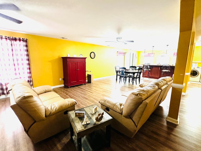 living room featuring ceiling fan, wood-type flooring, and washer / dryer