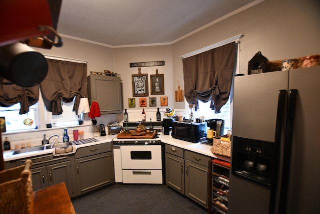 kitchen with a sink, stainless steel fridge, gray cabinetry, white gas stove, and ornamental molding