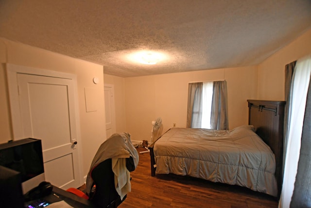 bedroom featuring a textured ceiling and wood finished floors