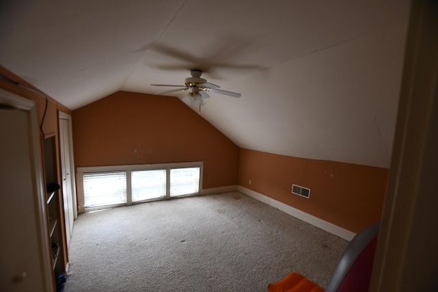 bonus room with lofted ceiling, carpet flooring, baseboards, ceiling fan, and visible vents
