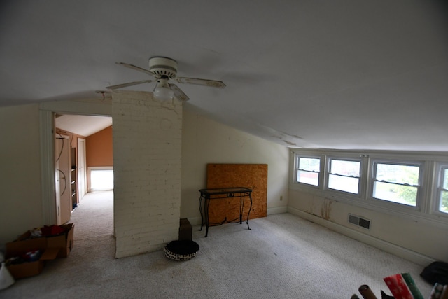 additional living space with visible vents, ceiling fan, carpet floors, and vaulted ceiling
