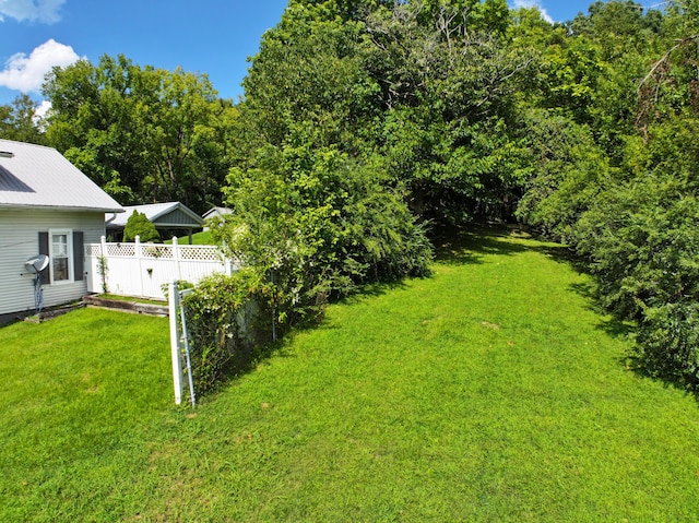 view of yard featuring a vegetable garden and fence