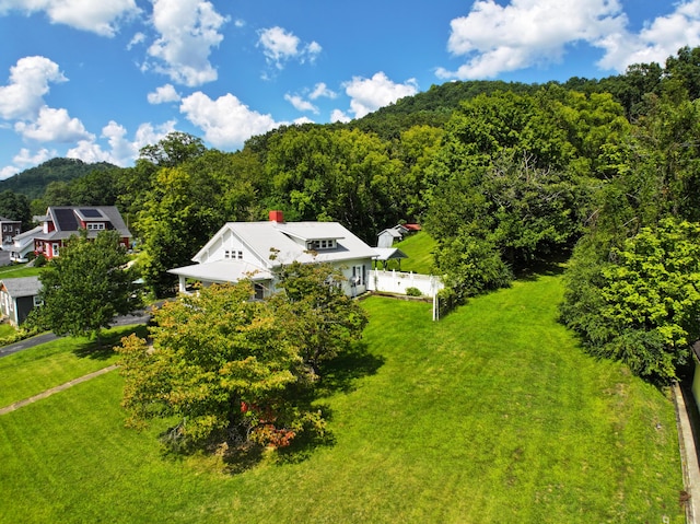 aerial view featuring a wooded view and a mountain view
