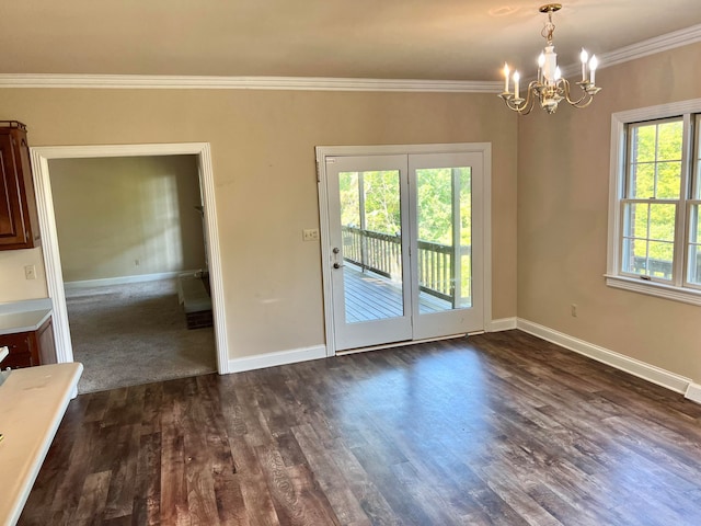 interior space featuring crown molding, dark hardwood / wood-style floors, a chandelier, and plenty of natural light