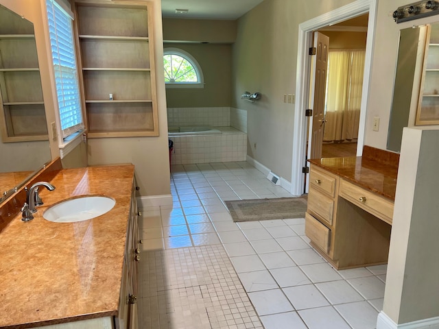 bathroom with tile patterned flooring, tiled bath, and vanity