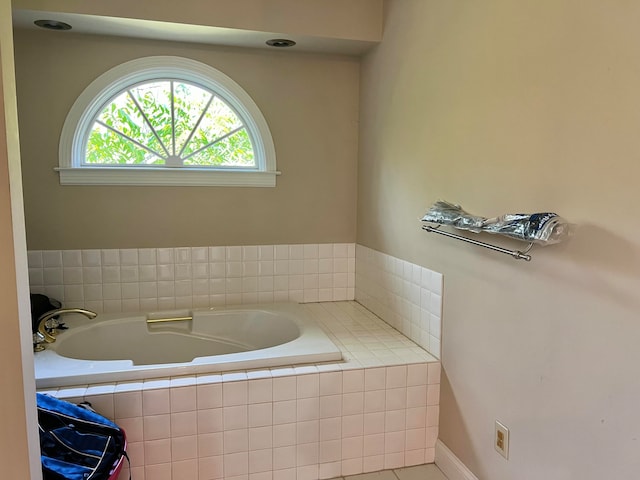 bathroom featuring tiled tub