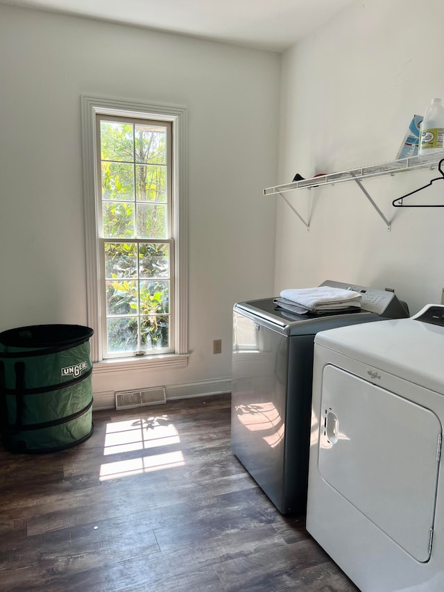 washroom with independent washer and dryer and dark wood-type flooring