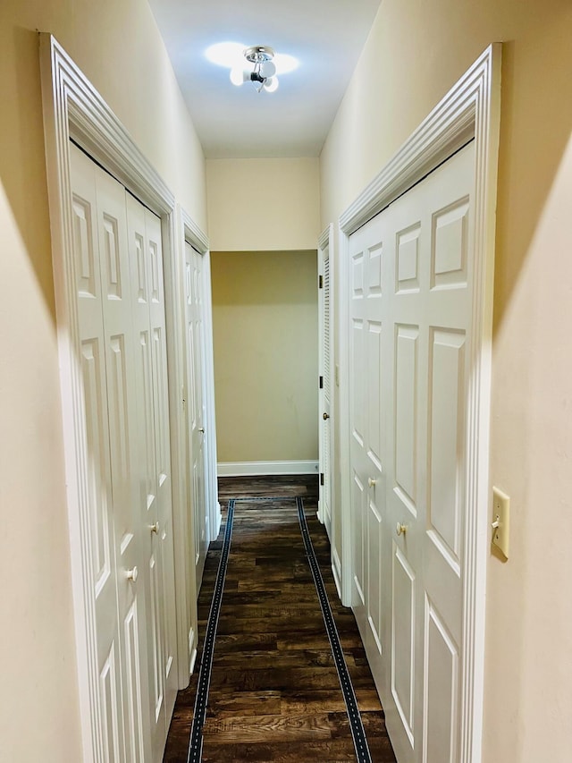 corridor with dark wood-type flooring