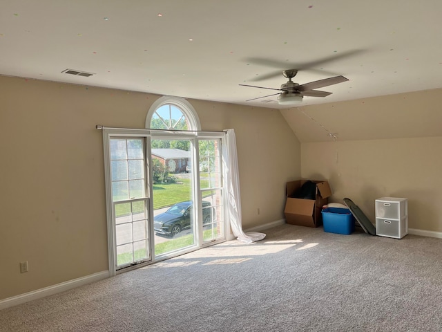 additional living space featuring vaulted ceiling, light carpet, and ceiling fan