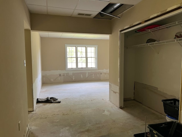 interior space with a closet and a paneled ceiling