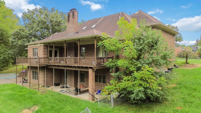 back of property with a lawn and a patio area