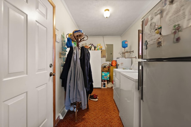 laundry room with ornamental molding, electric panel, washer and dryer, and water heater