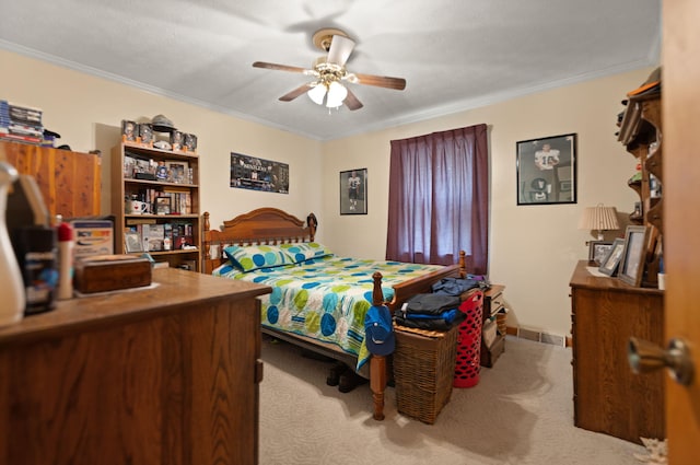 bedroom featuring ceiling fan, light colored carpet, and ornamental molding