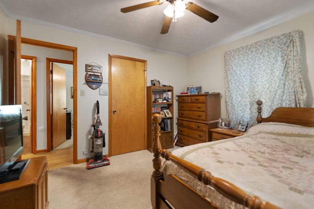 bedroom featuring ornamental molding, light carpet, and ceiling fan