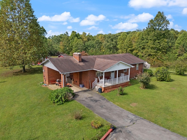 view of front of home with covered porch and a front yard