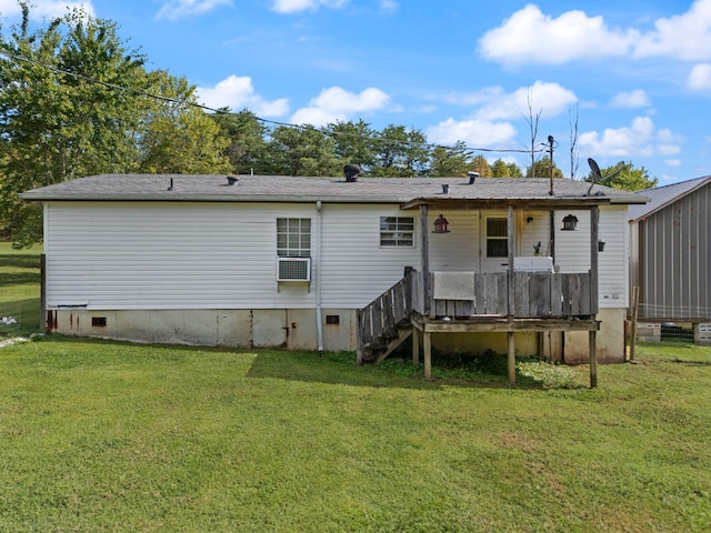 rear view of house with a wooden deck and a lawn