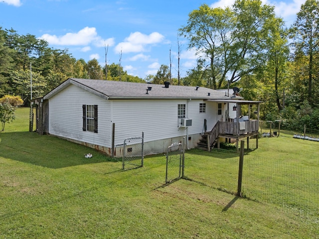 rear view of property featuring a lawn, a wooden deck, and cooling unit