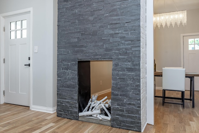 details featuring baseboards, wood finished floors, and a chandelier