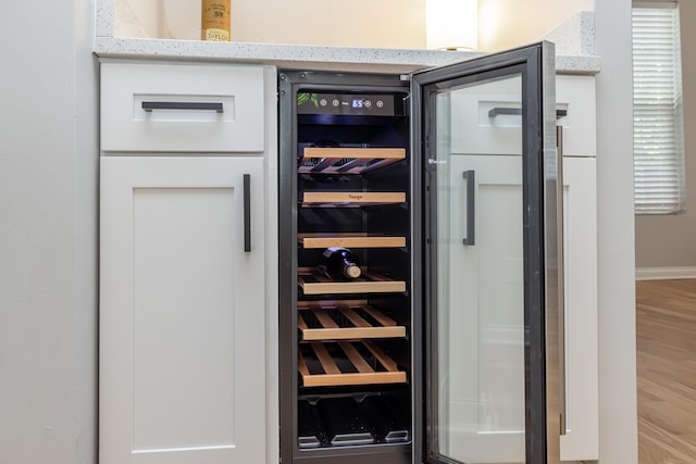 interior details with wine cooler and wood finished floors