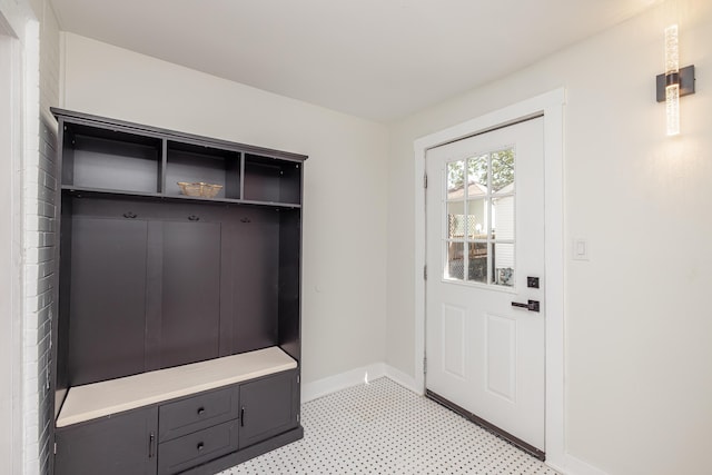 mudroom with light floors and baseboards