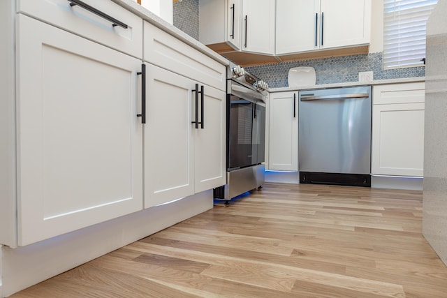 kitchen with white cabinetry, light wood-style flooring, and stainless steel appliances