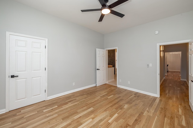 unfurnished bedroom featuring a ceiling fan, baseboards, and light wood-type flooring