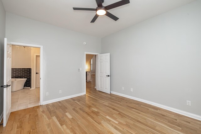 unfurnished bedroom featuring a ceiling fan, baseboards, and light wood finished floors