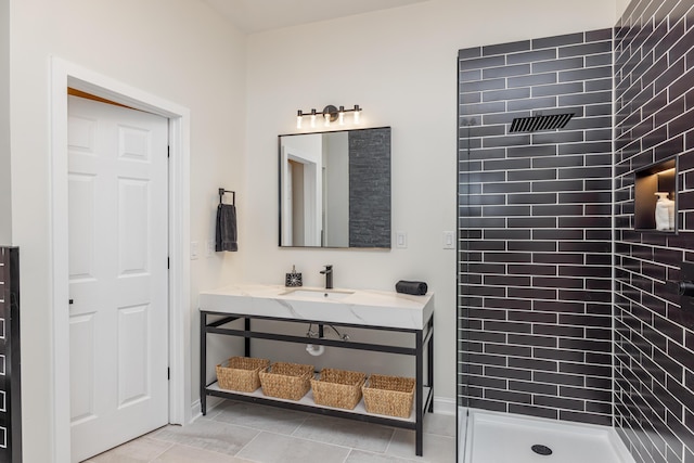 full bathroom featuring vanity, tile patterned floors, and a tile shower