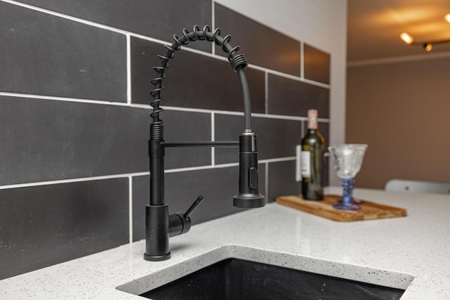 interior details with stone counters and a sink