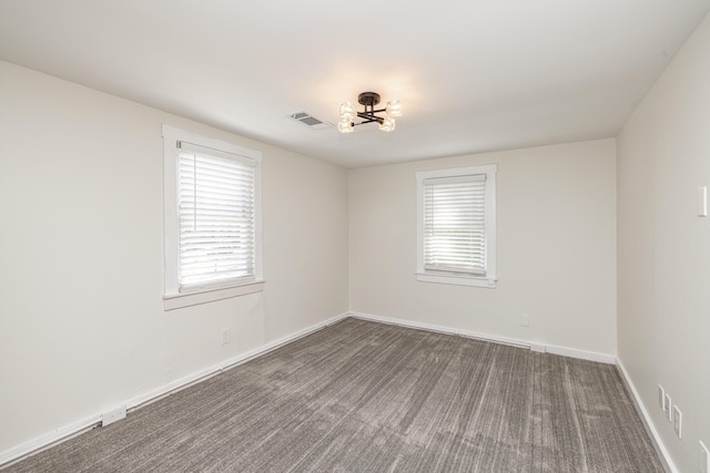 spare room featuring visible vents, baseboards, and carpet