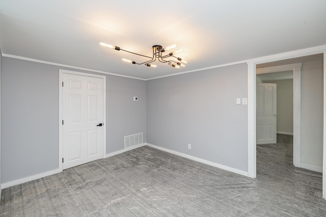 carpeted empty room featuring a notable chandelier, baseboards, visible vents, and ornamental molding