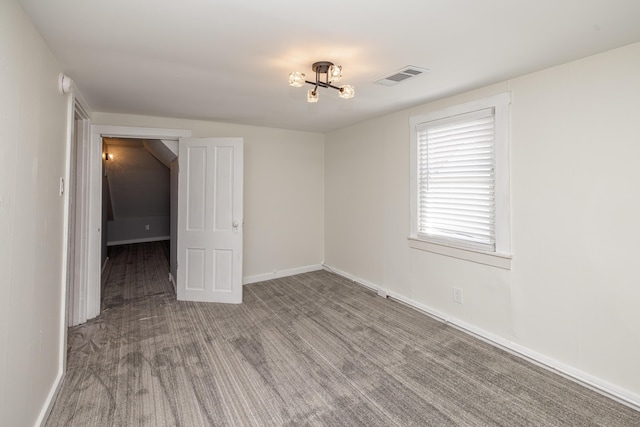 empty room featuring visible vents and baseboards