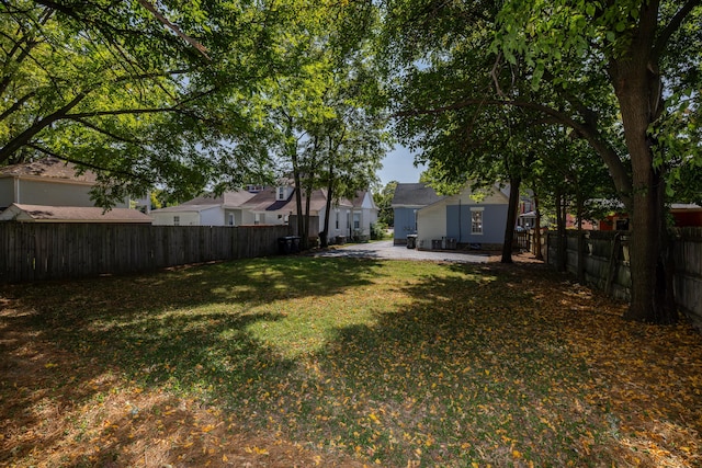 view of yard with a patio area, a residential view, and a fenced backyard