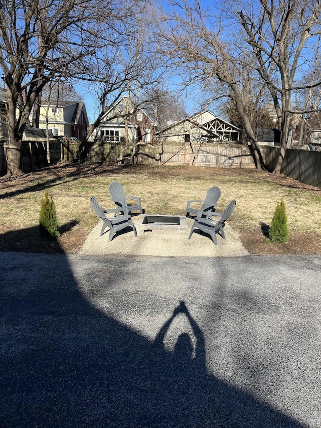 view of yard featuring an outdoor fire pit, a fenced backyard, and a patio