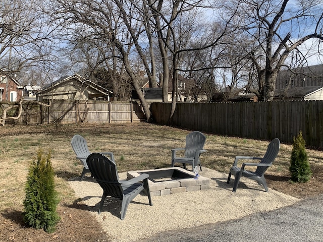 view of yard featuring a fire pit, a fenced backyard, and a patio area