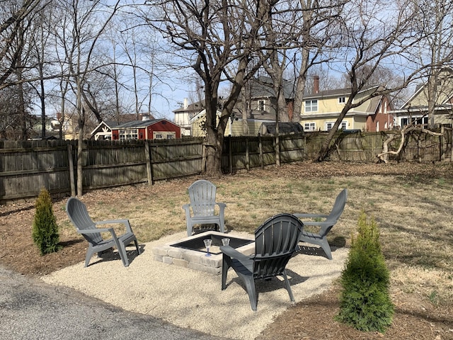 view of yard with a patio, a fenced backyard, a residential view, and a fire pit