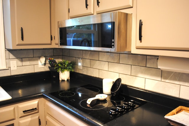 kitchen featuring black electric stovetop and backsplash