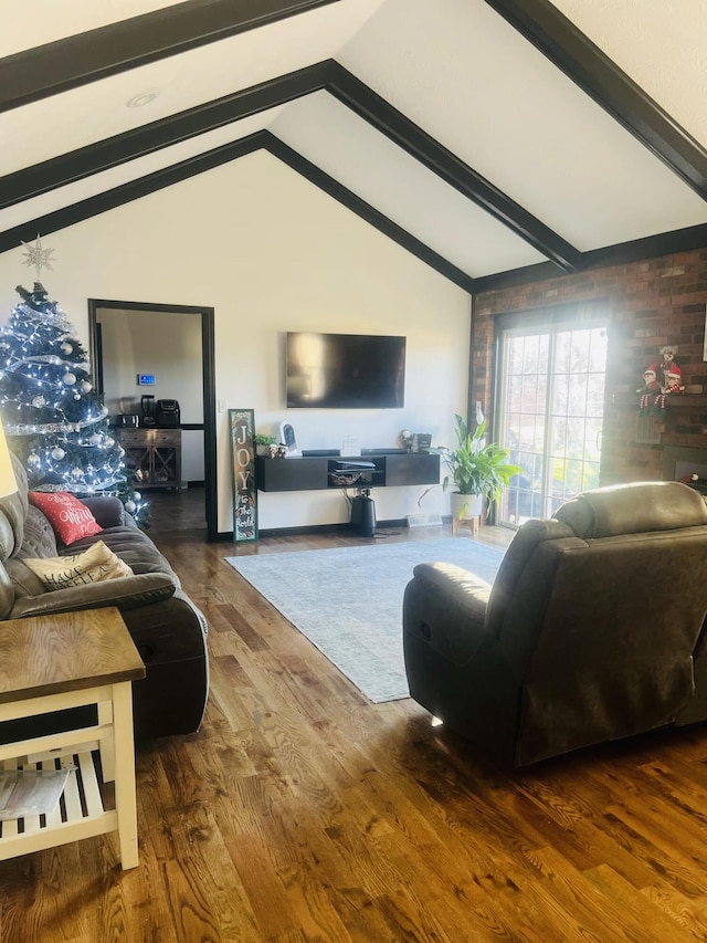 living room featuring lofted ceiling with beams and wood-type flooring