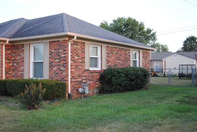 view of side of home with a lawn