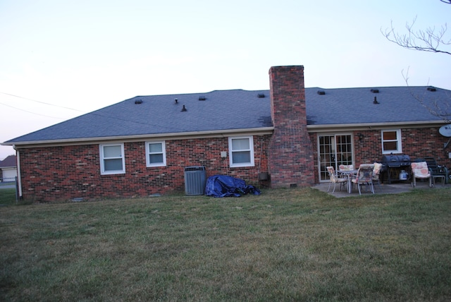 back of property featuring a yard, a patio, and cooling unit