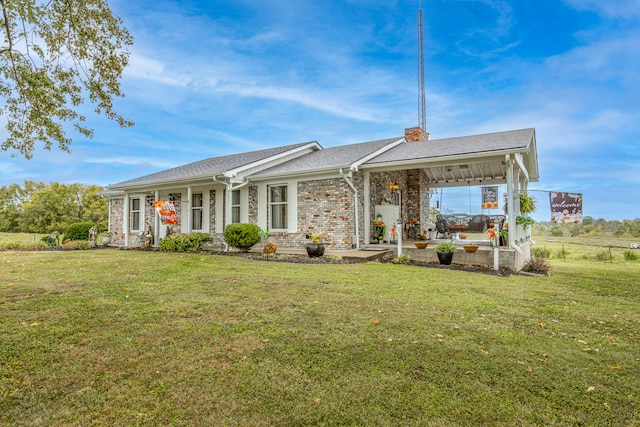 rear view of property with ceiling fan, a lawn, and a patio