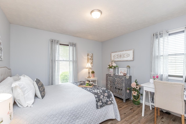 bedroom featuring a textured ceiling and hardwood / wood-style floors